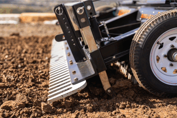 Ground Preparation for Turf: Building the Foundation for Successful Vegetation Establishment 60 A Vortec Rippa-Rake attachment performing professional ground preparation by loosening and leveling soil to create a perfect seedbed.